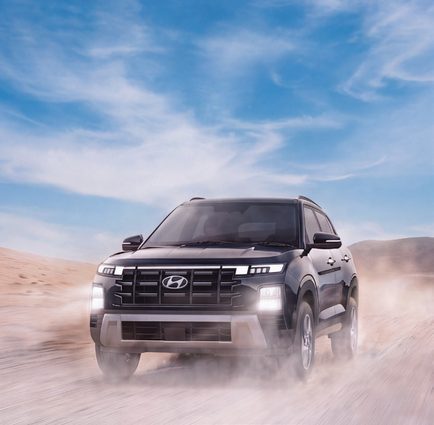 Hyundai SUV crossing a sandy landscape