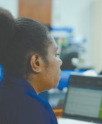 First Investment Finance team member working at a computer