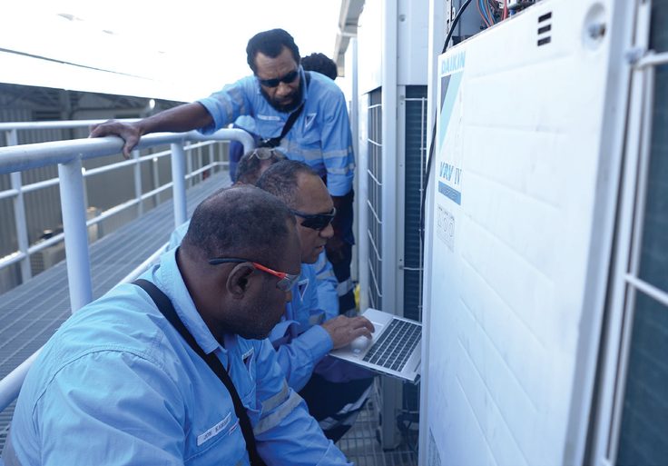 Daikin technicians servicing outdoor air-conditioning equipment