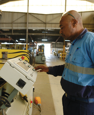 Technician operating equipment in the Daikin workshop