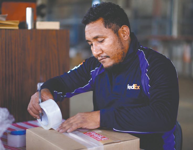PNG Air Freight employee preparing a shipment