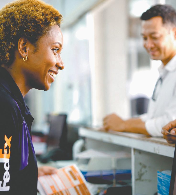 PNG Air Freight employee assisting a customer at the service counter